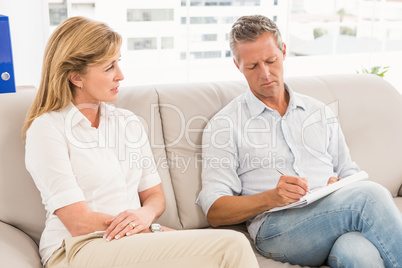 Concerned therapist talking with female patient