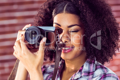 Attractive young woman photographing with camera