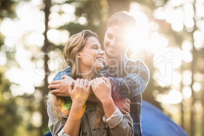 Happy young camper couple looking at each other