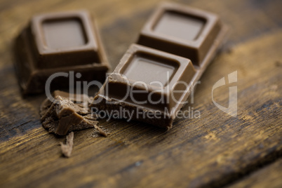 Pieces of chocolate on a wooden table