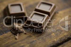 Pieces of chocolate on a wooden table