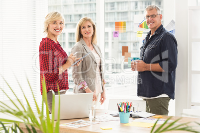 Standing business team looking at the camera