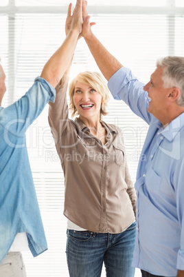 Smiling business colleagues giving high-five