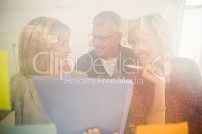 Smiling business team working over a tablet