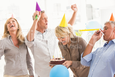 Casual business people celebrating birthday and having fun
