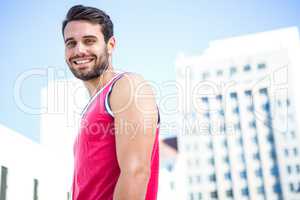 Smiling handsome athlete looking at the camera