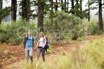 Young hiker couple hiking and pointing