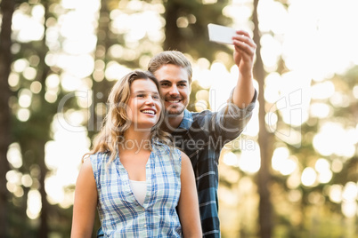 Happy smiling couple embracing and taking selfies