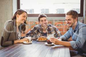 Smiling friends looking at smartphone