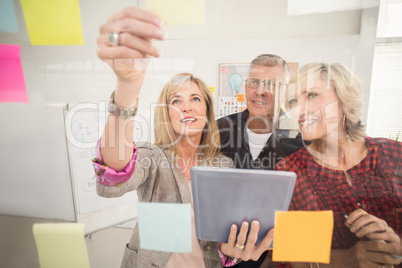 Smiling business team working on tablet