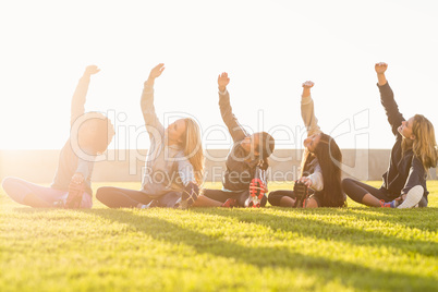 Sporty women stretching during fitness class