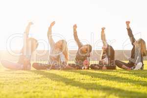 Sporty women stretching during fitness class