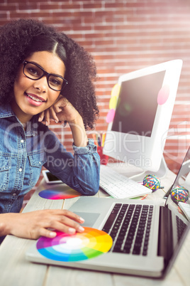 Casual female designer using laptop