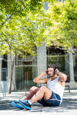 Handsome athlete doing sit ups