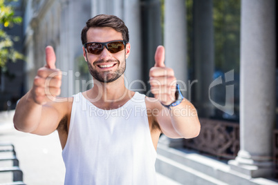 Smiling handsome athlete doing thumbs up