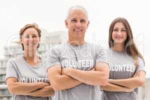 Smiling volunteers with arms crossed