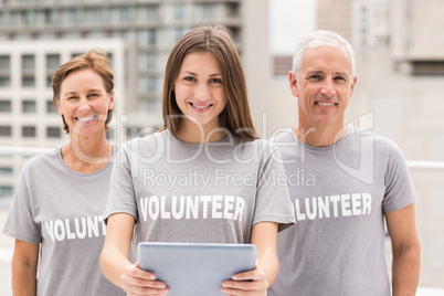 Smiling volunteers with tablet