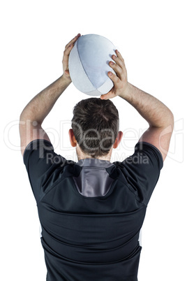 Back turned rugby player throwing a ball