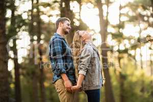 Happy smiling couple standing behind each other