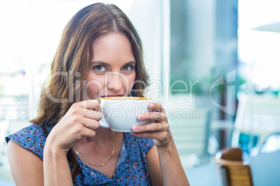 Pretty brunette having a coffee