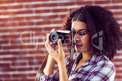 Attractive hipster photographing with camera