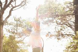 Carefree blonde hiker with arms outstretched