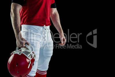 American football player holding his helmet