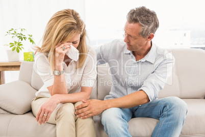 Concerned therapist comforting crying female patient