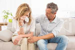 Concerned therapist comforting crying female patient