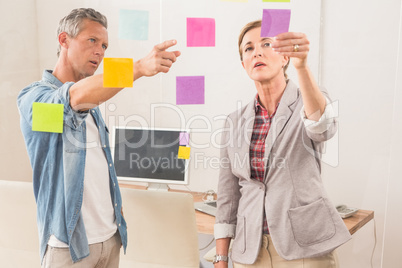 Casual business colleagues working with sticky notes