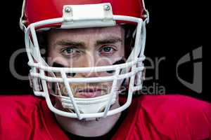 Portrait of focused american football player wearing his helmet