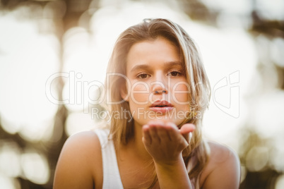 Pretty young jogger blowing kiss