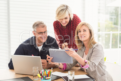 Happy business team working over a tablet