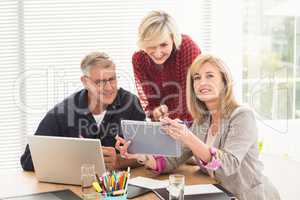 Happy business team working over a tablet