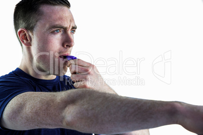 An attentive trainer blowing his whistle