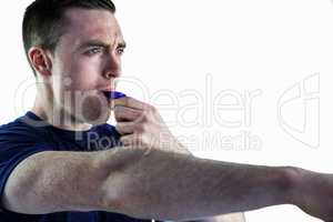 An attentive trainer blowing his whistle