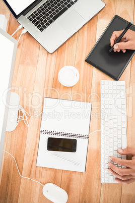 Hands working with computer and digitizer