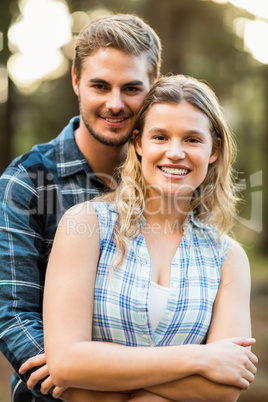 Happy smiling couple embracing and looking at the camera