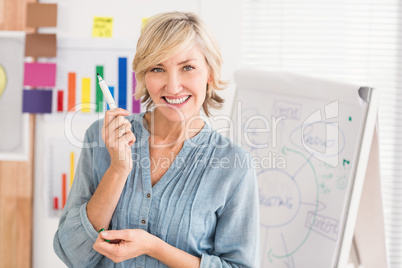 Happy businesswoman holding a marker