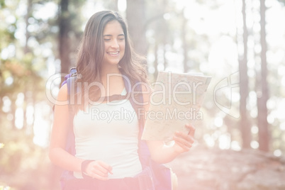 Young happy jogger looking at map