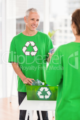 Smiling eco-minded man with recycling box