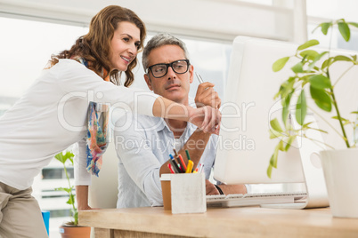 Two casual designers working with computer