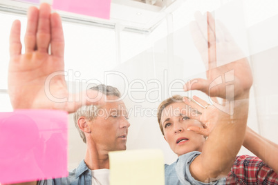 Casual business colleagues working with sticky notes