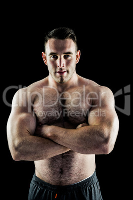 Handsome bodybuilder with arms crossed