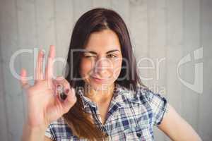 Pretty hipster making ok sign with hand