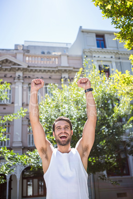 Handsome athlete gesturing victory