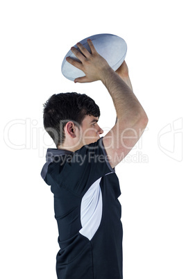 Profile view of rugby player throwing a ball