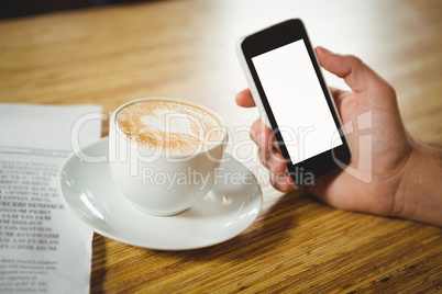 High angle close-up of coffee and smartphone