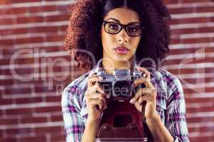 Attractive focused hipster photographing