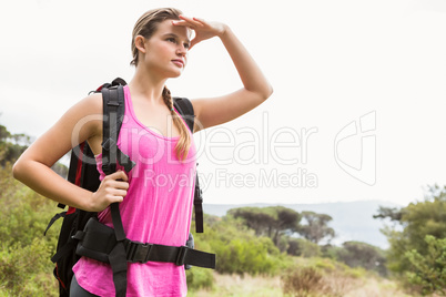 Blonde hiker looking for path